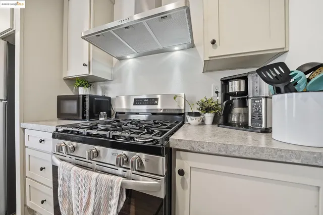 a kitchen with stainless steel appliances granite countertop a stove and a sink
