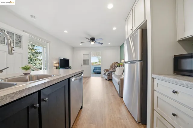 a kitchen with stainless steel appliances granite countertop a refrigerator and a sink