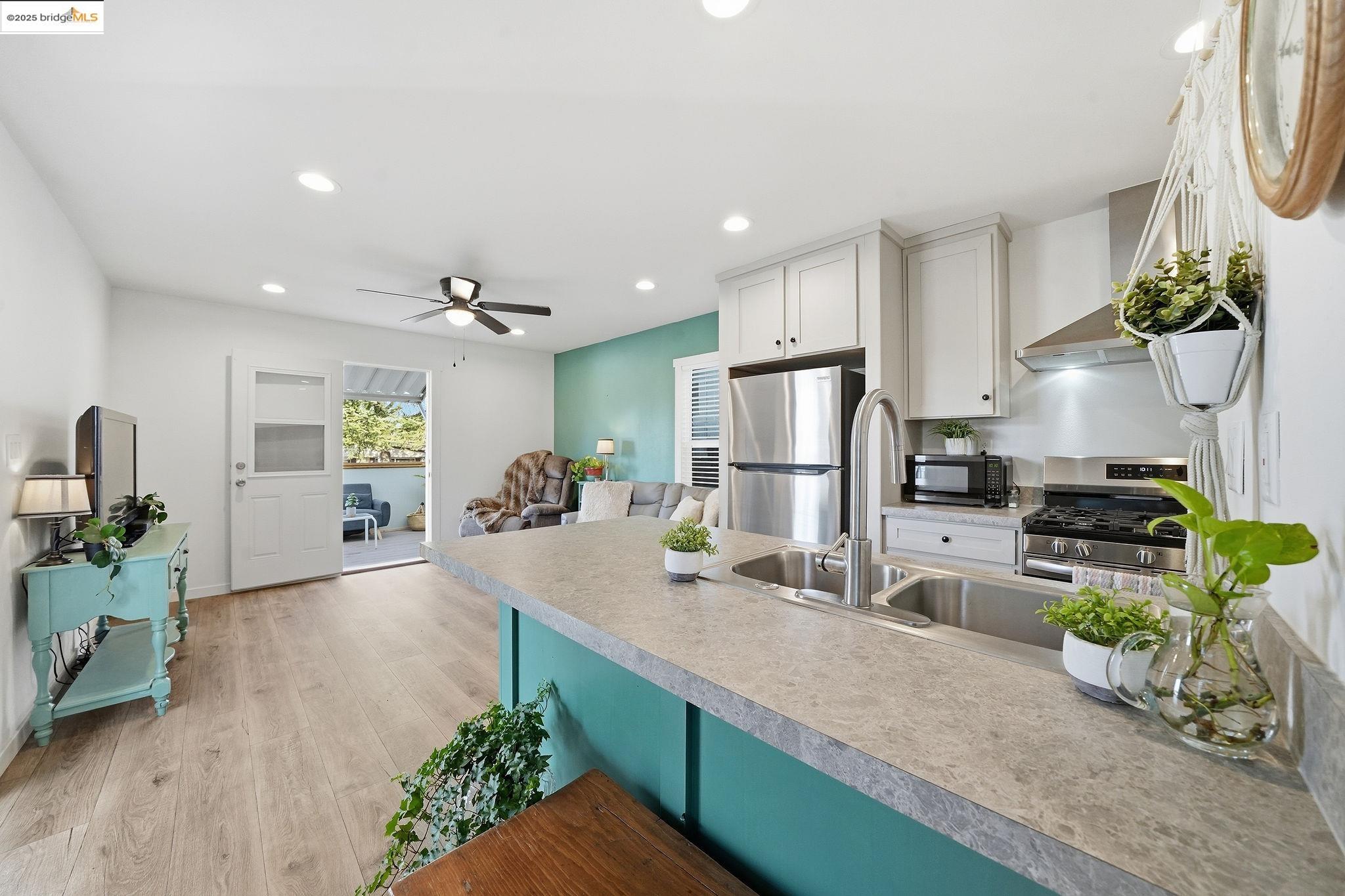 150 Clinton Road Jackson, CA 95642 - Photo 28 of 44 Kitchen featuring white cabinets, light countertops, light wood-style floors, recessed lighting, and appliances with stainless steel finishes
