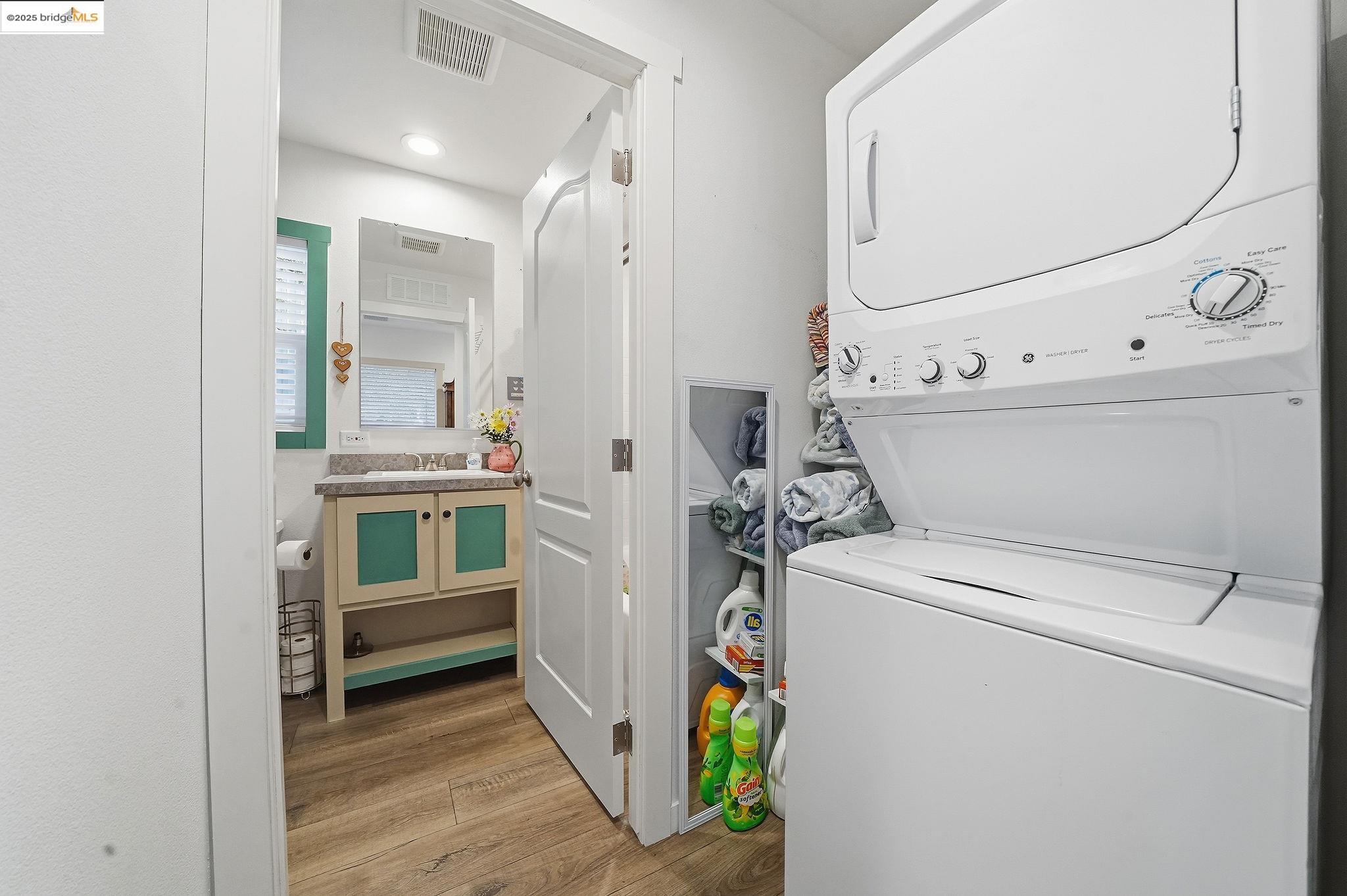 150 Clinton Road Jackson, CA 95642 - Photo 29 of 44 Laundry area featuring light wood-type flooring and stacked washing machine and dryer