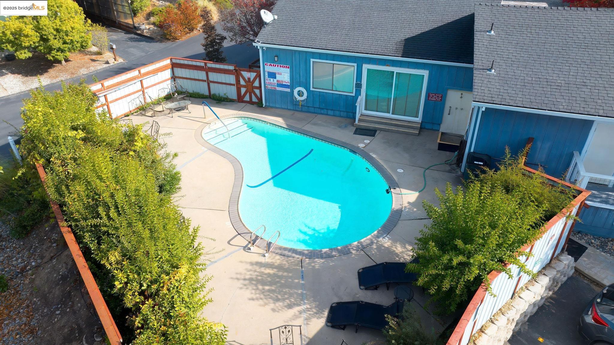 150 Clinton Road Jackson, CA 95642 - Photo 41 of 44 Community pool with a fenced backyard and a patio