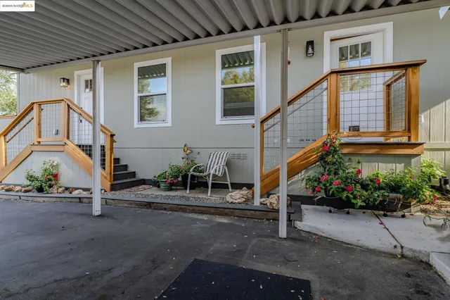 a house with lots of trees in front of it