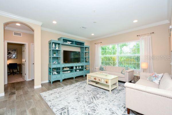 4212 Expedition Way Osprey, FL 34229 - Photo 6 of 28 a living room with furniture and a flat screen tv