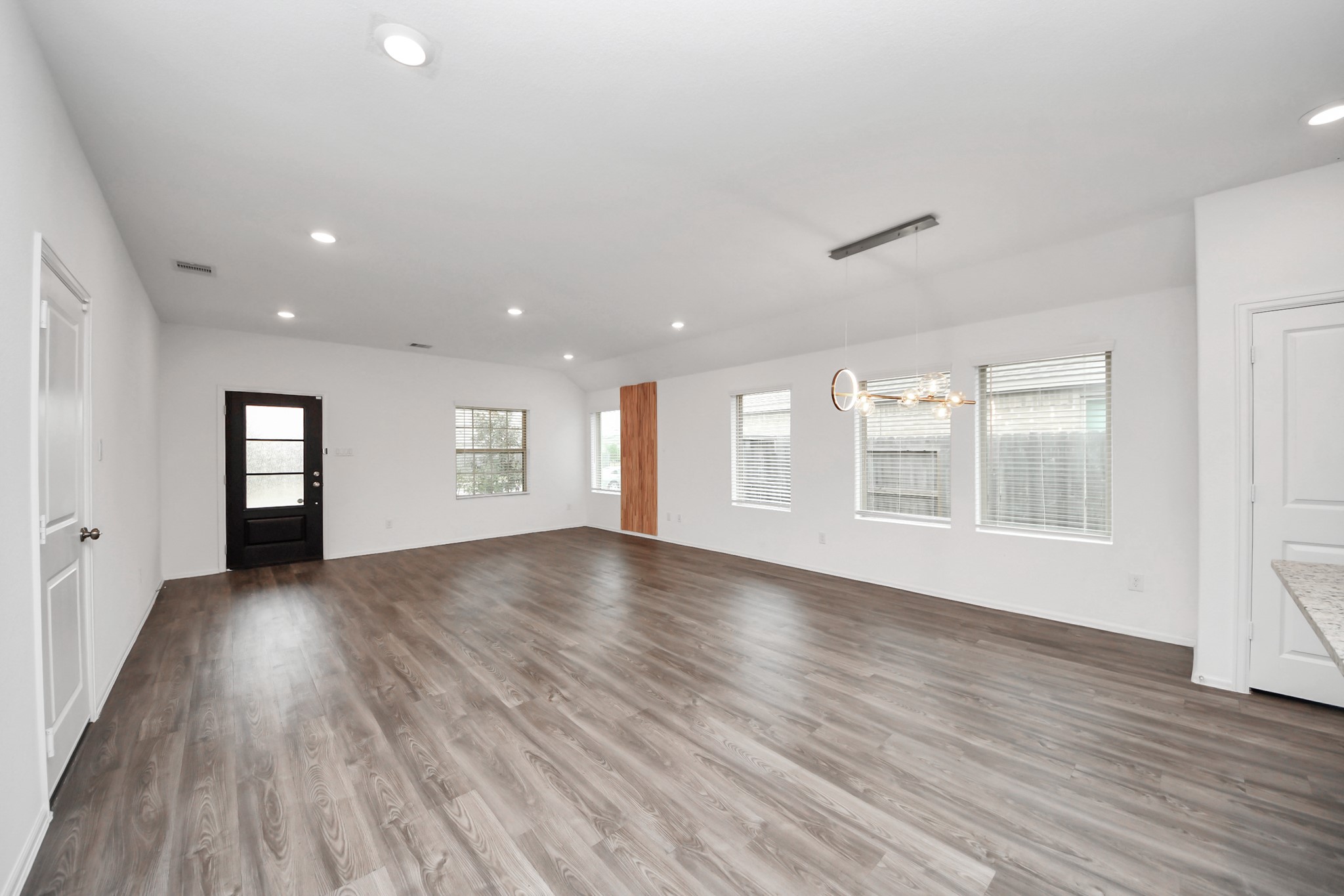 14230 Elrington Holw Trail Rosharon, TX 77583 - Photo 14 of 42 a view of an empty room with wooden floor and a window