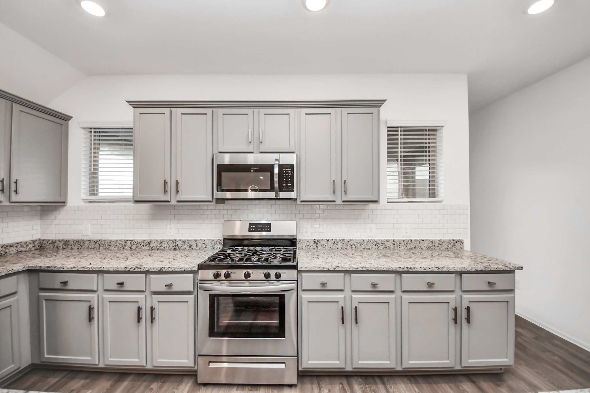 14230 Elrington Holw Trail Rosharon, TX 77583 - Photo 19 of 42 a kitchen with granite countertop white cabinets and appliances