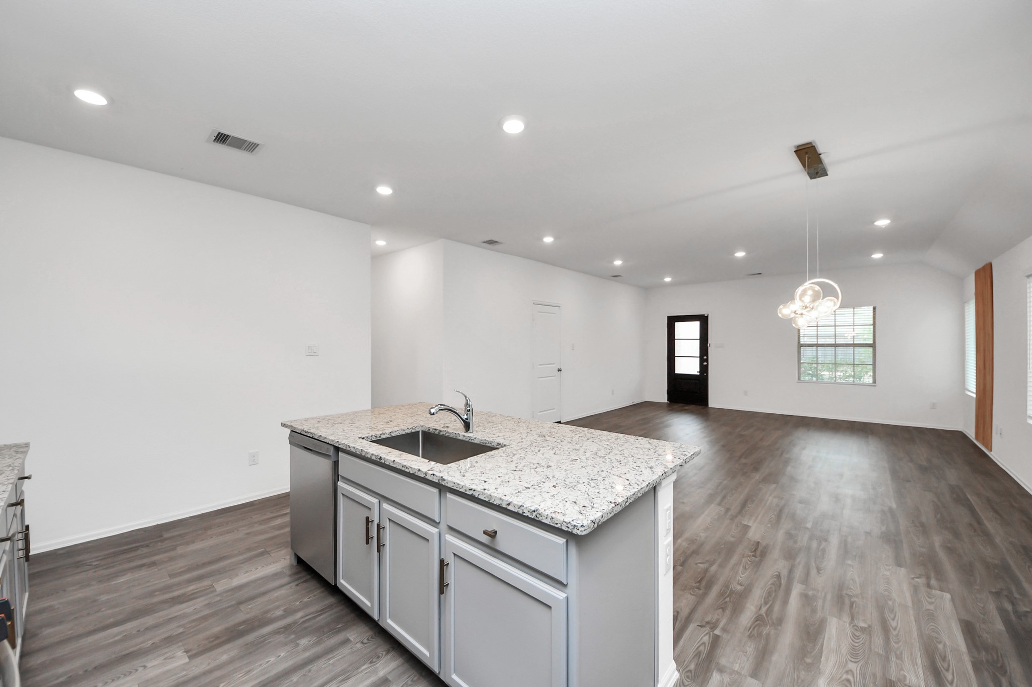 14230 Elrington Holw Trail Rosharon, TX 77583 - Photo 20 of 42 a kitchen with granite countertop kitchen island a sink stove and wooden floor