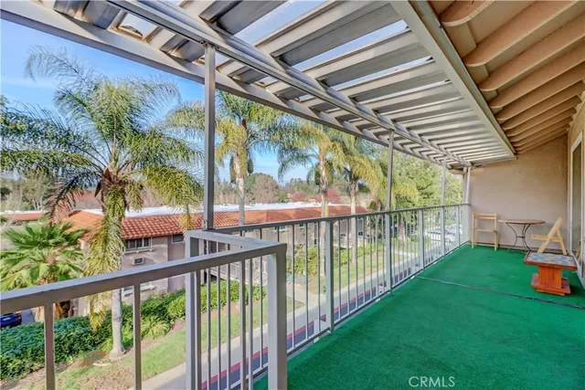 a view of a hallway with workspace and a window