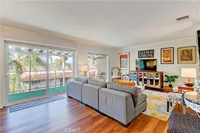a living room with furniture large window and flat screen tv