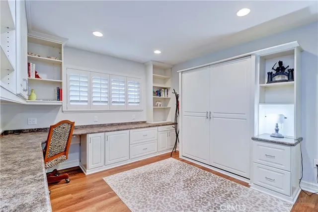 a kitchen with granite countertop a stove a sink and cabinets