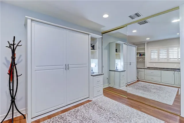 a bathroom with a granite countertop sink a toilet a shower and a mirror