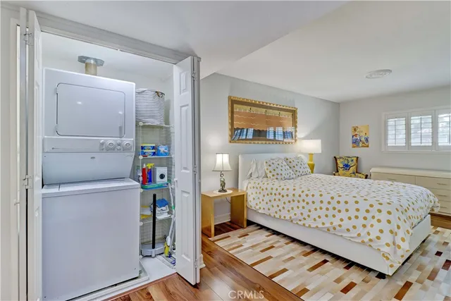 a bedroom with a large bed and a lamp on table