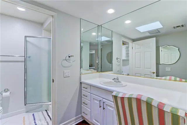a bathroom with a sink a light fixture and a mirror
