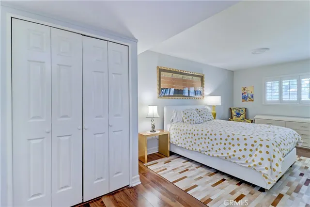 a bedroom with a bed and a painting on the wall