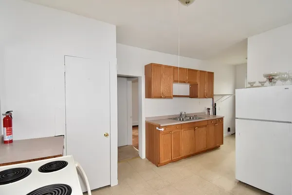 a kitchen with stainless steel appliances a refrigerator sink and cabinets