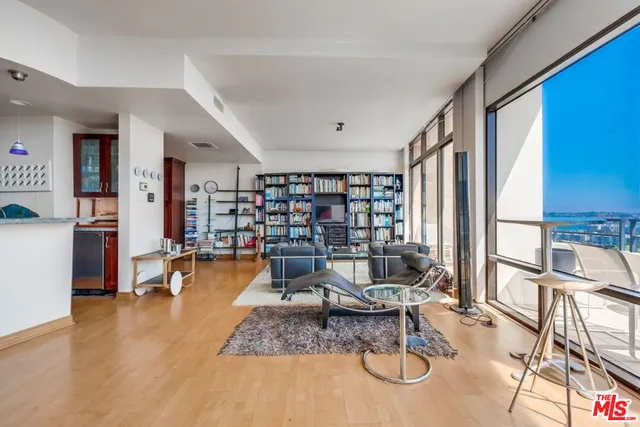 a living room with furniture and a book shelf