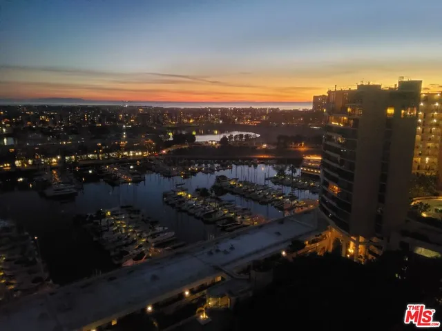 a balcony with outdoor seating and city view