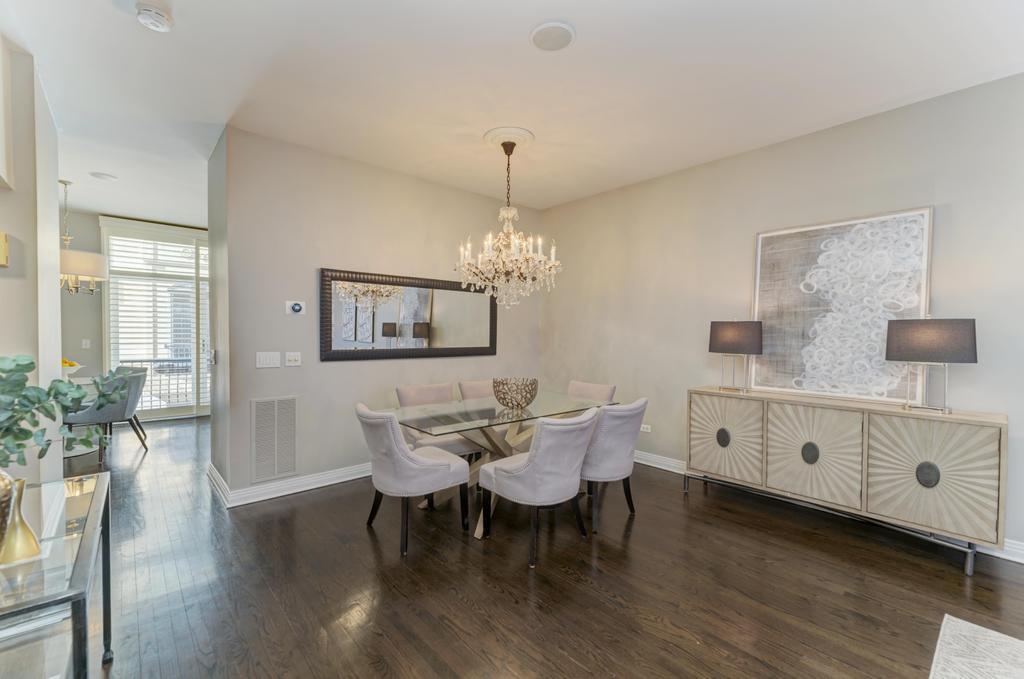 512 North Peoria Street Chicago, IL 60642 - Photo 11 of 32 a dining room with furniture a chandelier and wooden floor