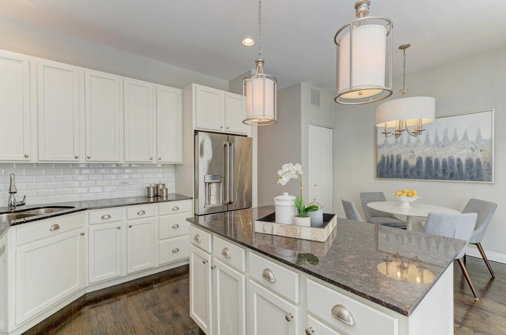512 North Peoria Street Chicago, IL 60642 - Photo 15 of 32 a kitchen with granite countertop a sink a stove and cabinets