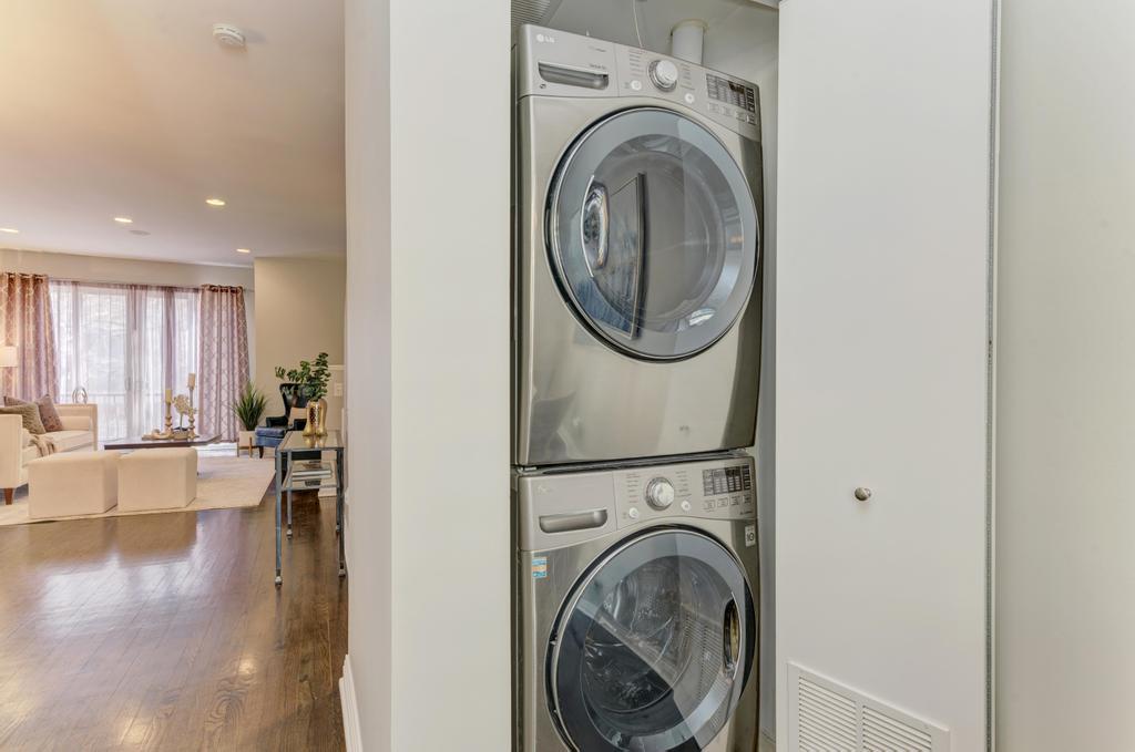 512 North Peoria Street Chicago, IL 60642 - Photo 18 of 32 a view of a hallway with washer and dryer