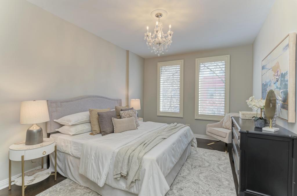 512 North Peoria Street Chicago, IL 60642 - Photo 19 of 32 a bedroom with a bed and a chandelier