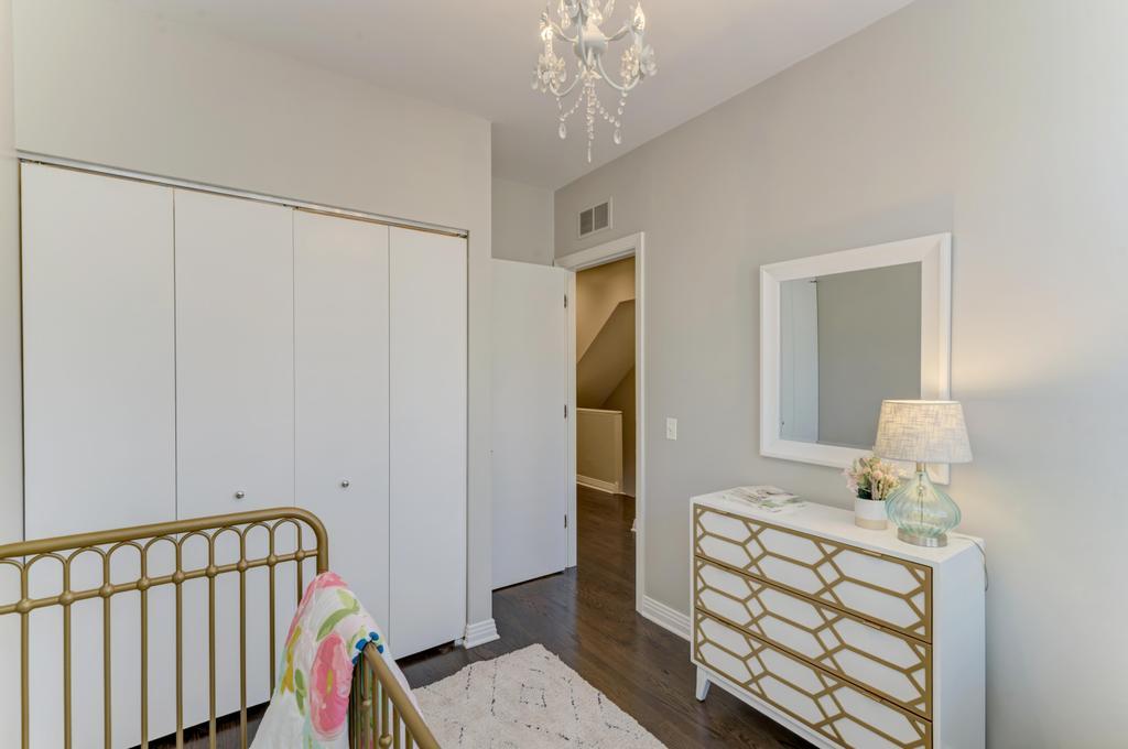 512 North Peoria Street Chicago, IL 60642 - Photo 29 of 32 a bedroom with a bed and wooden floor
