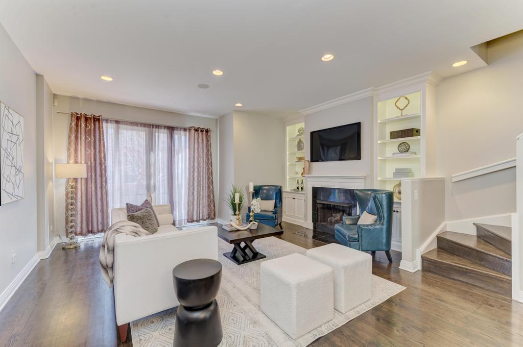 512 North Peoria Street Chicago, IL 60642 - Photo 8 of 32 a living room with furniture a fireplace and a flat screen tv