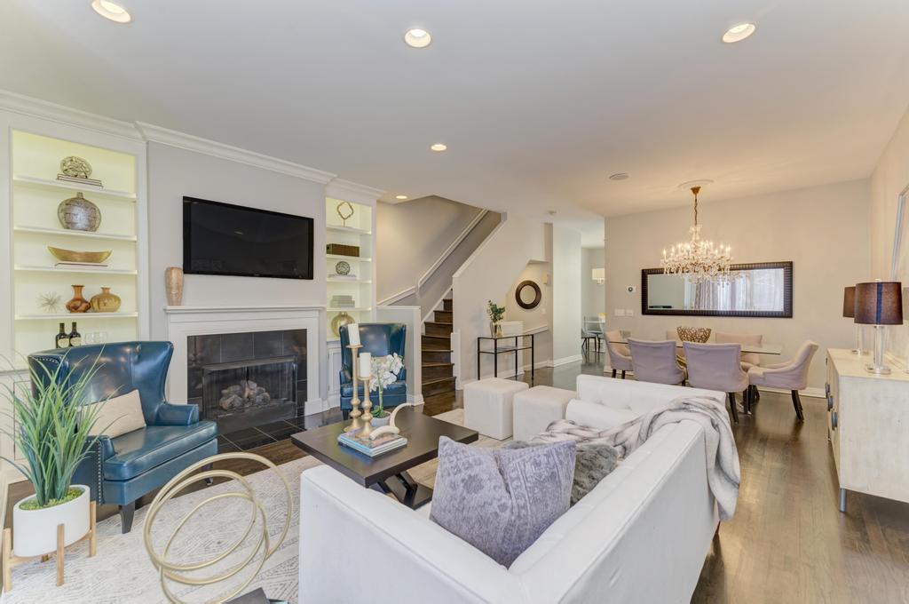 512 North Peoria Street Chicago, IL 60642 - Photo 9 of 32 a living room with furniture a fireplace and a flat screen tv