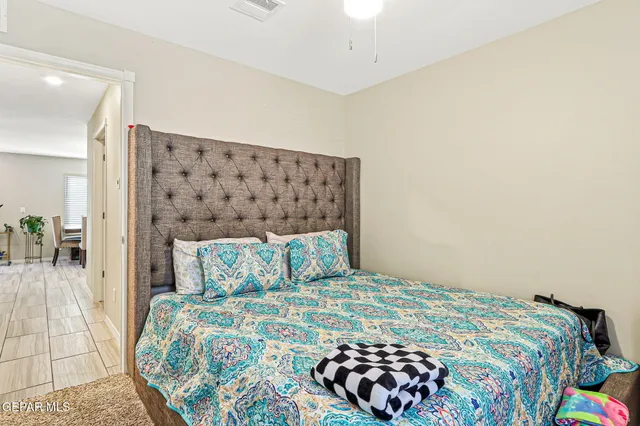 a bedroom with a bed and wooden floor