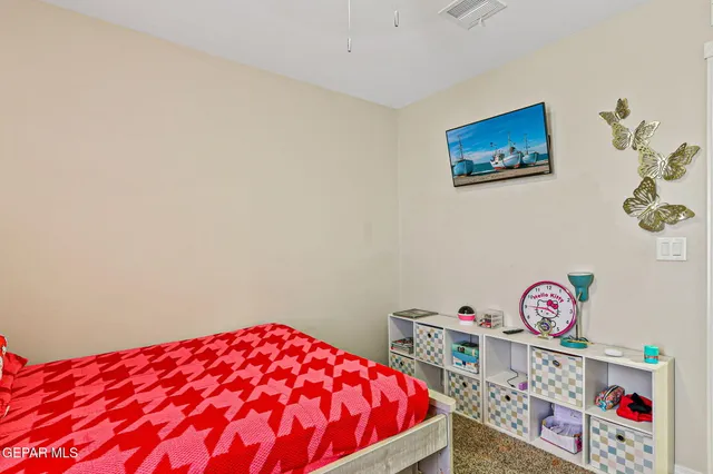 a bedroom with a bed and a dresser