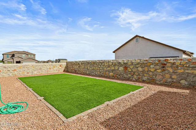 a view of a backyard with sitting area