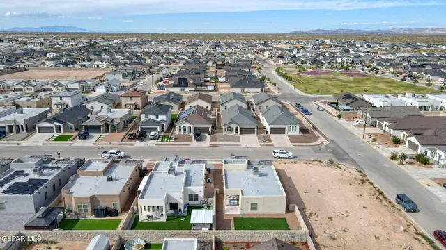 an aerial view of residential houses with yard