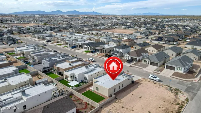 an aerial view of residential houses with outdoor space