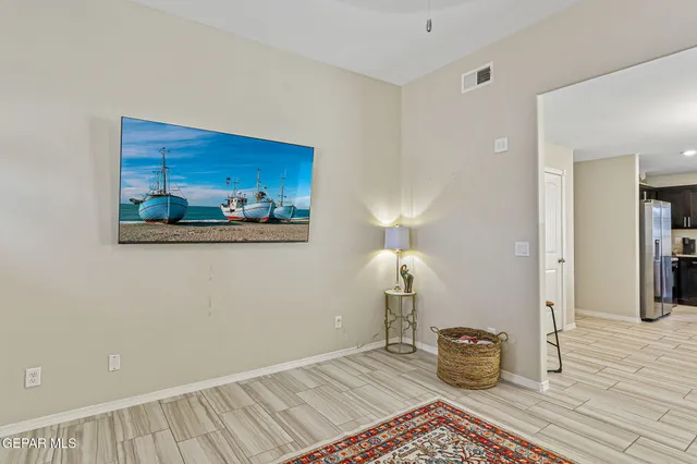 a view of a room with wooden floor and cabinet
