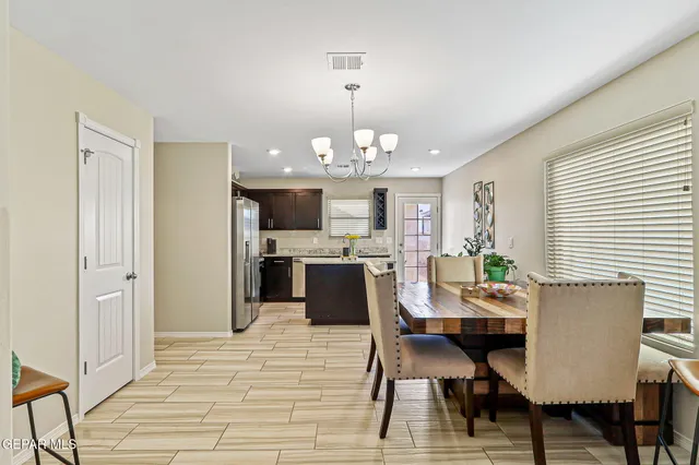 a view of a dining room with furniture and chandelier