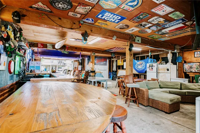 a view of a patio with table and chairs with a barbeque grill and couches