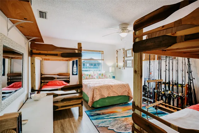 a bedroom with a bed and wooden floor
