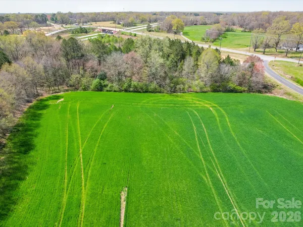 a view of a green field with an outdoor space