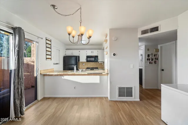 a kitchen with granite countertop a refrigerator stove and sink