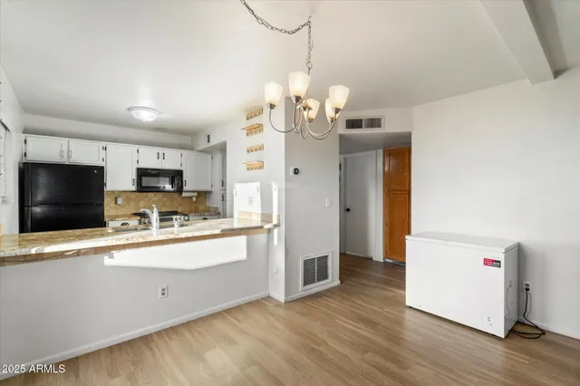 a view of a kitchen with a sink wooden floor and a kitchen view