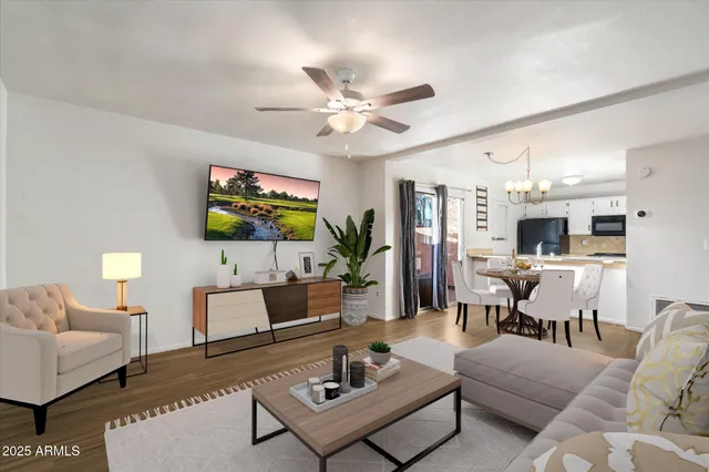 a view of a kitchen with wooden floor and a kitchen space with a sink