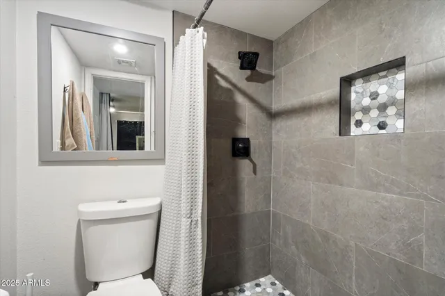 a backyard of a house with couches and glass door