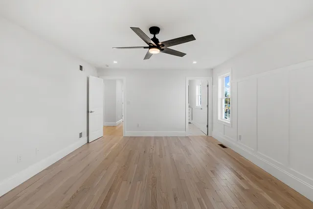 a bathroom with a sink a toilet a mirror and shower