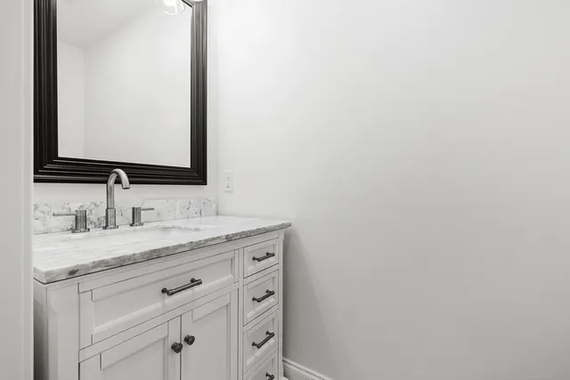 an empty room with a window and a ceiling fan