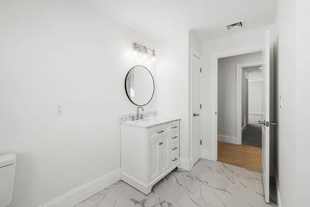 a view of a room with a ceiling fan and window