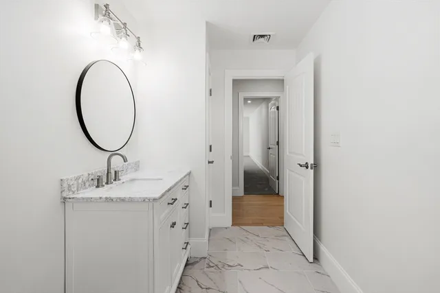 wooden floor fireplace and windows in an empty room