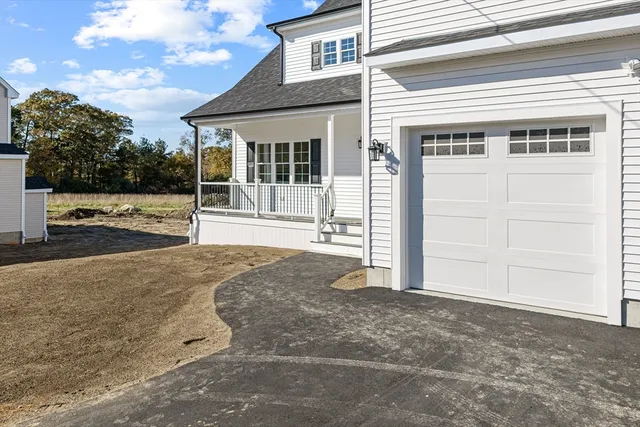a kitchen with a stove a sink a kitchen island with wooden floor cabinets and floor to ceiling window