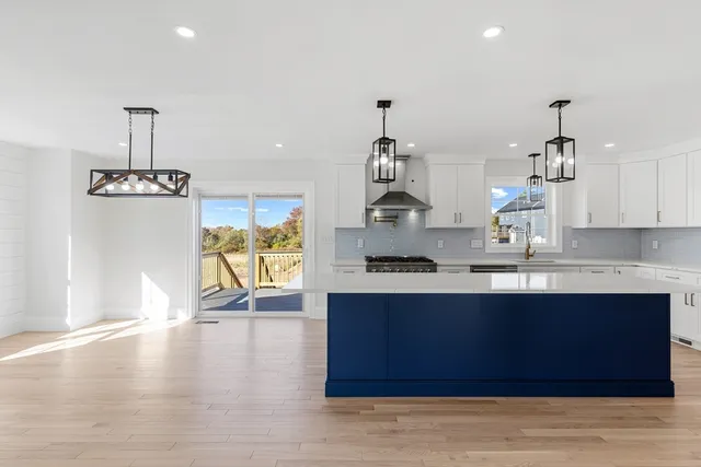 a kitchen with stainless steel appliances granite countertop a stove a sink and a refrigerator