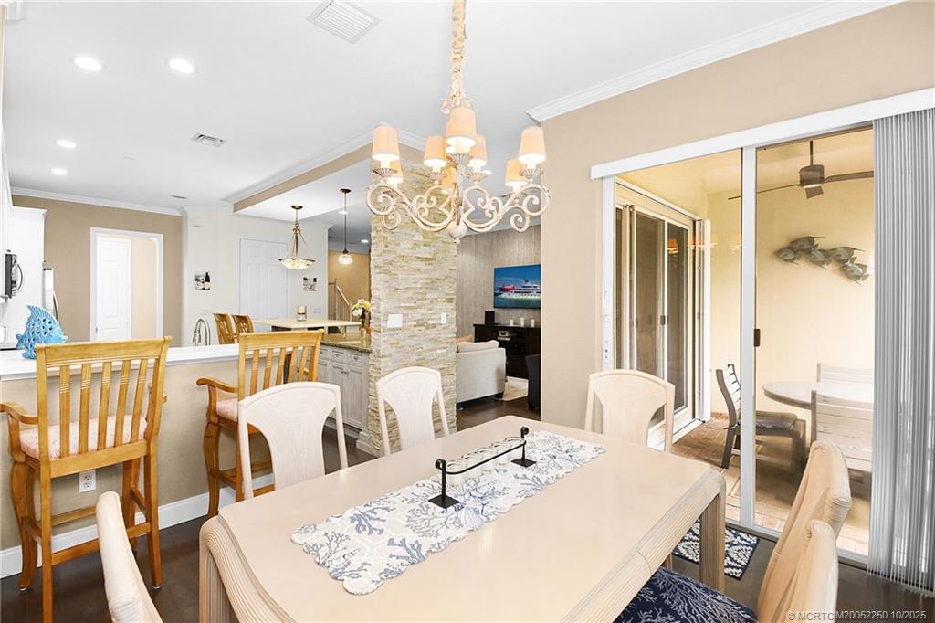 254 Southwest Walking Path Stuart, FL 34997 - Photo 14 of 31 a view of a dining room with furniture a chandelier and wooden floor