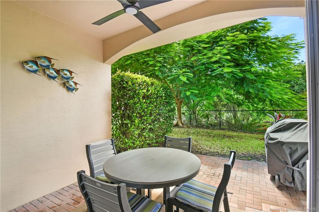 254 Southwest Walking Path Stuart, FL 34997 - Photo 26 of 31 a view of a backyard with table and chairs potted plants and a backyard