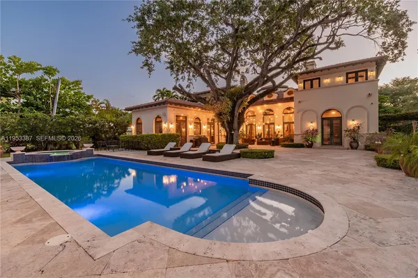 a view of swimming pool with outdoor seating and covered with trees